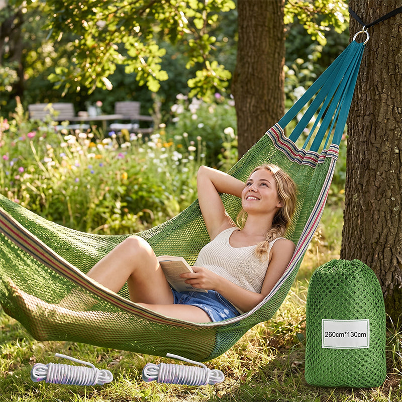 Arenzza upgraded camping hammock with ropes, shown hanging outdoors, designed for comfortable outdoor relaxation and camping adventures.