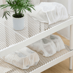 Arenzza reusable drawstring shoe storage bag showing black fabric with drawstring closure, ideal for organizing shoes.