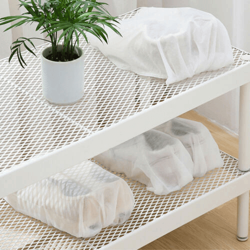 Arenzza reusable drawstring shoe storage bag showing black fabric with drawstring closure, ideal for organizing shoes.