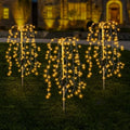 Colorful LuminaGlow™ Solar Firework Garden Lights by Arenzza, waterproof starburst stake lamps illuminating paths, patios, and gardens.