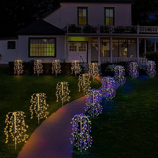 Aarenzza LuminaGlow™ Solar Firework Garden Lights in multi-color, waterproof starburst stake lamps illuminating a garden path.