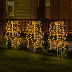 Aarenza LuminaGlow™ Solar Firework Garden Lights in multi-color, waterproof starburst stake lamps illuminating a garden path at night.