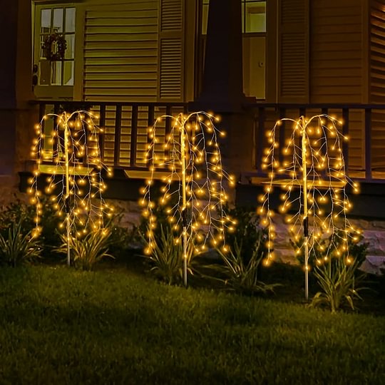 Aarenza LuminaGlow™ Solar Firework Garden Lights in multi-color, waterproof starburst stake lamps illuminating a garden path at night.