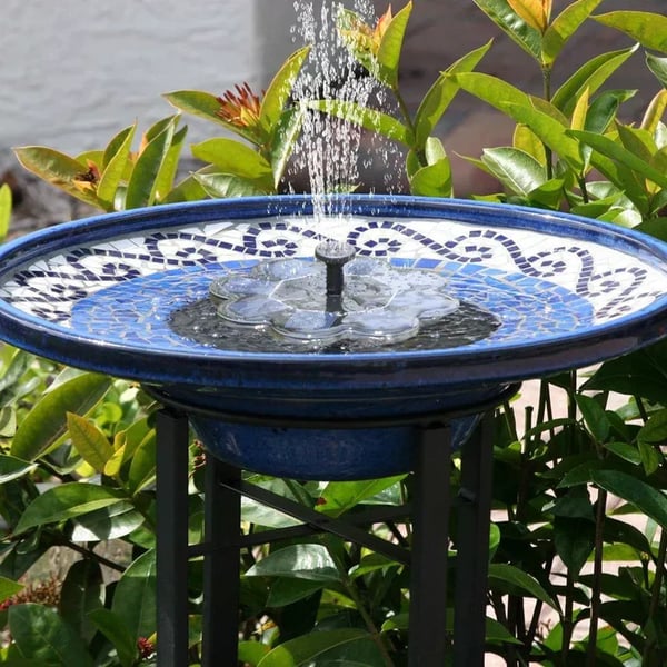 Arenzza solar-powered garden fountain with a compact design, featuring a water spout and solar panel in a lush garden setting