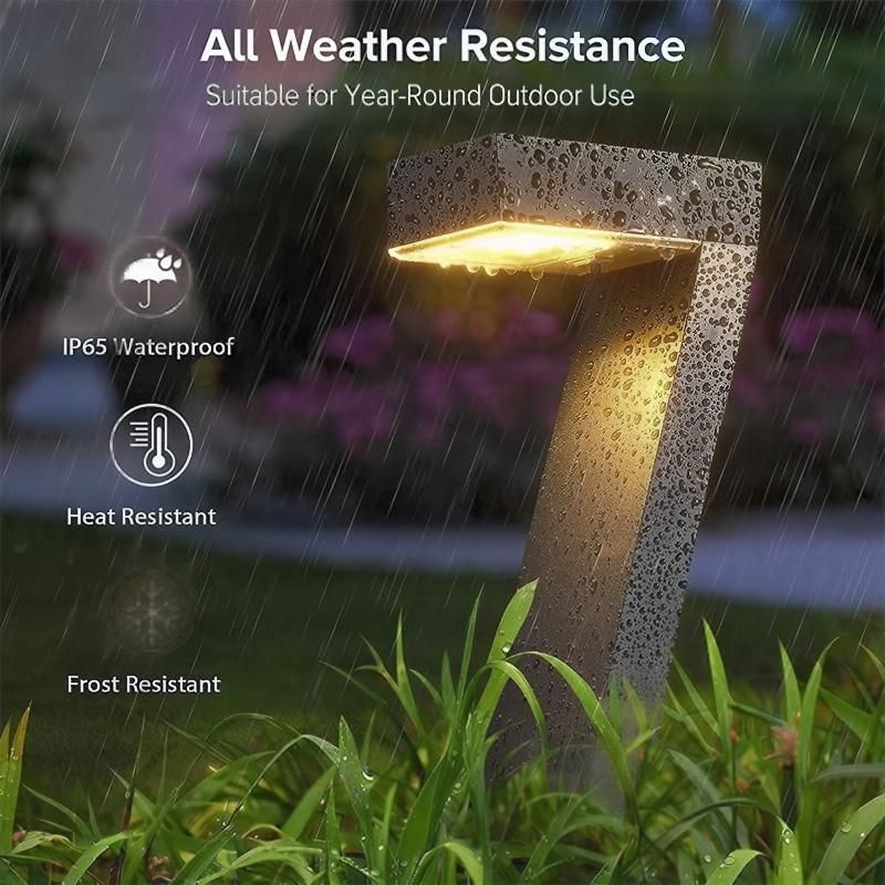 Aarenza waterproof solar pathway lights in a garden setting, with black stakes and clear plastic covers illuminating a pathway.