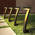 Aarenza waterproof solar pathway lights in garden setting, illuminating a stone walkway with bright LED lights for outdoor lighting.