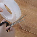Arenzza clear double-sided tape for tools and garden use, shown in a roll with its strong, removable adhesive on a white background.