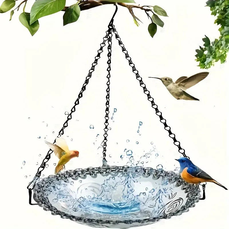Arenzza Solar Cascade Hanging Bird Bath Fountain with cascading water, garden tools and birdbath in a garden setting.