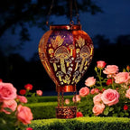 Aarenzza solar-powered hot air balloon lantern in a garden setting, showcasing its colorful fabric and lightweight design.