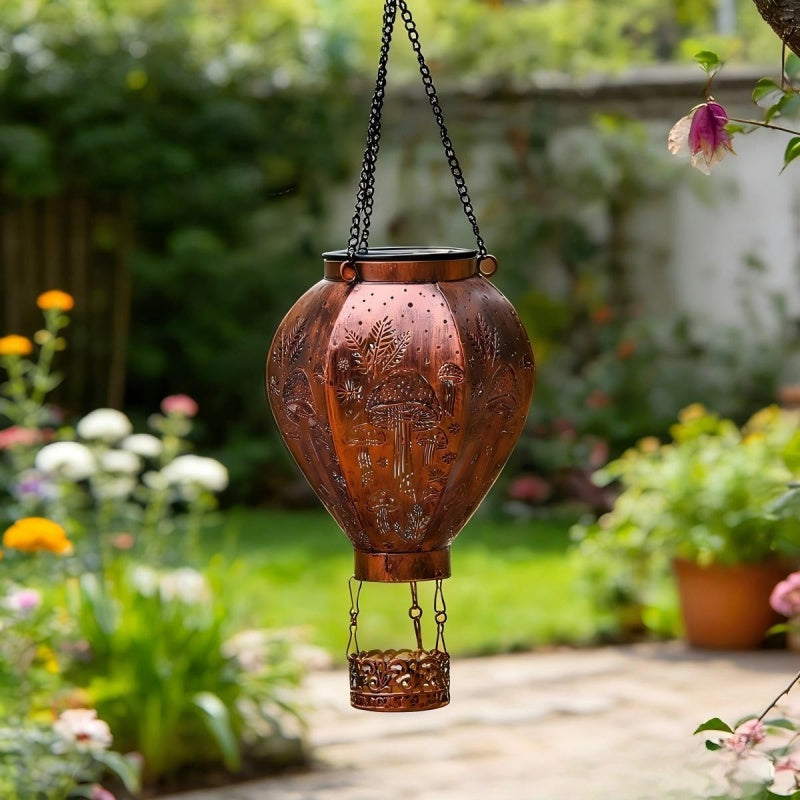 Aarenza solar-powered hot air balloon lantern in tools and garden, showcasing the lantern with a colorful balloon design outdoors.
