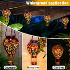 Solar-powered hot air balloon lantern from Arenzza, hanging outdoors with a colorful fabric envelope and a sturdy metal basket.