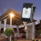 Arenzza outdoor solar clip light with motion sensor, mounted on a garden wall, illuminating the area at night