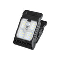Arenzza outdoor solar clip light with motion sensor, mounted on garden wall, illuminating the area at night with bright light.