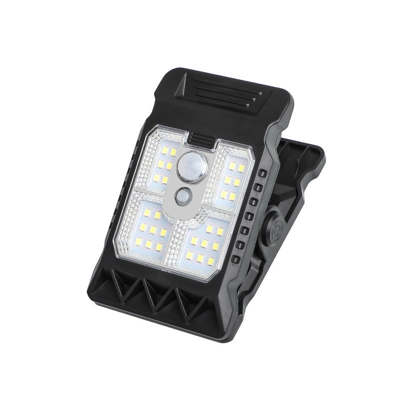 Arenzza outdoor solar clip light with motion sensor, mounted on garden wall, illuminating the area at night with bright light.