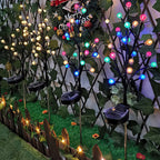Arenzza solar-powered LED garden stake light resembling a tree branch, installed in a garden setting for decorative lighting.