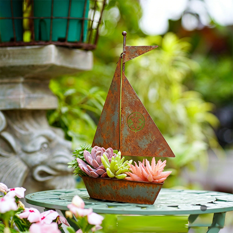 Rustic Arenzza metal sailboat planter, weather-resistant for succulents, herbs, or flowers, ideal for garden or shelf decor.