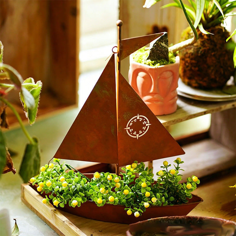 Rustic metal sailboat planter by Arenzza, weather-resistant for succulents, herbs, or flowers, ideal for garden or shelf decor.