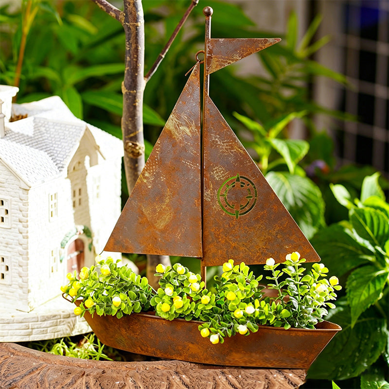 Rustic metal sailboat planter by Arenzza, weather-resistant for succulents, herbs, or flowers, ideal for garden or shelf decor.