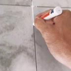 Arenzza Tile Marker Grout Pen for tools and garden, showing the pen being used to mark or repair grout lines on tiles.
