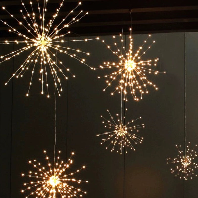 Aarenza solar fireworks light string in a garden setting, featuring colorful LED lights on a flexible string for outdoor parties.