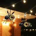 Aarenzza outdoor hanging solar bee light in garden, showcasing its whimsical bee design and solar panel for eco-friendly lighting.