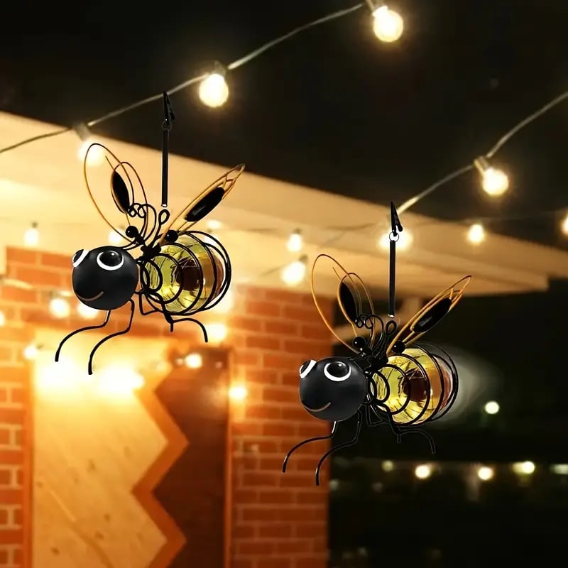 Aarenzza outdoor hanging solar bee light in garden, showcasing its whimsical bee design and solar panel for eco-friendly lighting.