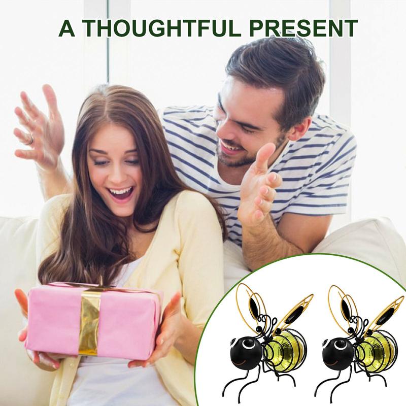 Arenzza outdoor hanging solar bee light with black metal frame and warm LED glow, perfect for garden or patio decoration.