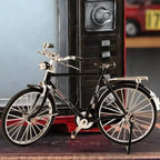 A detailed Arenzza DIY bicycle model toy for kids and gifts, showing assembled miniature bicycle with intricate parts.