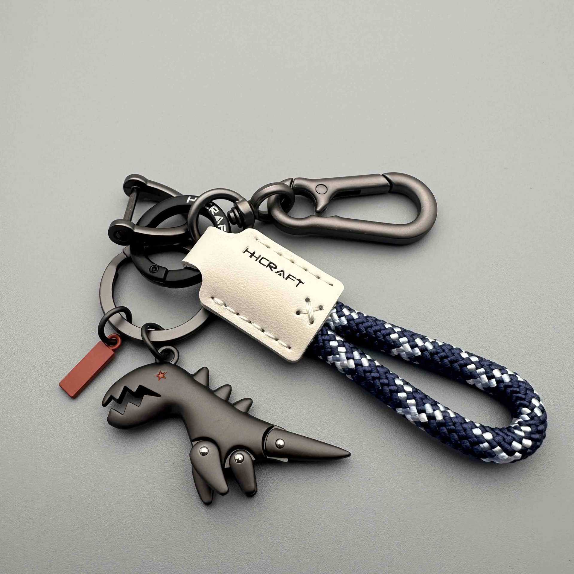 Arenzza aluminum alloy dinosaur charm paired with a hand-woven bracelet, perfect as a kids' toy or gift accessory.