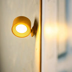 Arenzza wireless magnetic wall lamp with a 360° rotating light mounted on a wall, showcasing its sleek modern design and adjustable head.