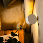 Arenzza wireless magnetic wall lamp with 360° rotating light mounted on a wall, showcasing its sleek modern design and adjustable features.