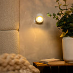 Arenzza wireless magnetic wall lamp with 360° rotating light, mounted on a wall, showcasing its sleek design and adjustable lighting.
