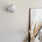 Arenzza wireless magnetic wall lamp with 360° rotating light, modern design, and built-in rechargeable battery, mounted on a wall.