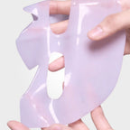 A woman with a pink deep collagen gel mask applied to her face, showcasing the Aurenza Shop collagen skincare treatment.