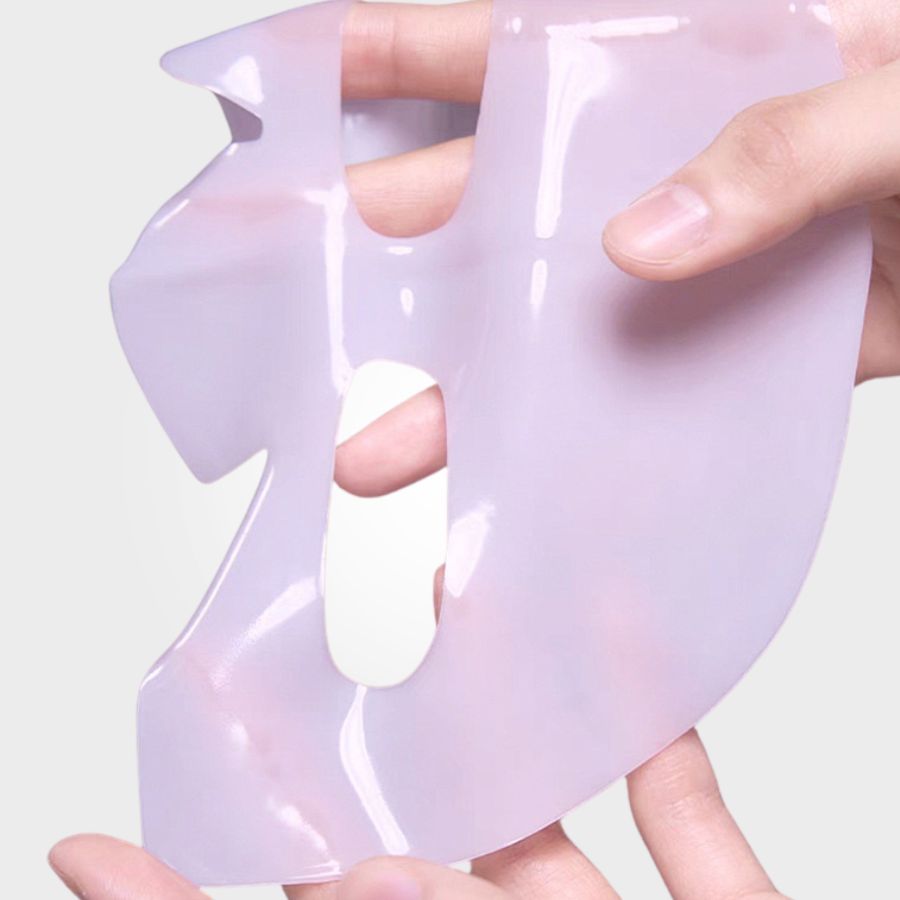 A woman with a pink deep collagen gel mask applied to her face, showcasing the Aurenza Shop collagen skincare treatment.