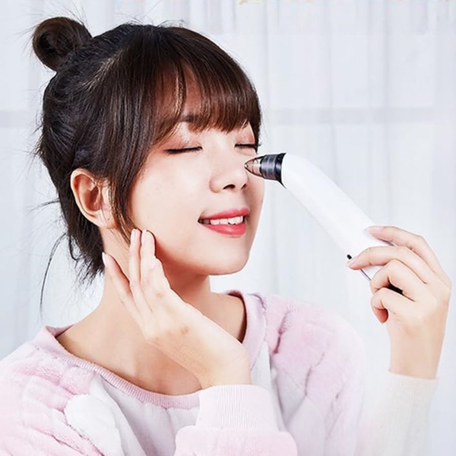 Aurenza Blackhead Remover Pore Vacuum Cleaner showing a handheld device with a clear suction head for skin pore cleansing.