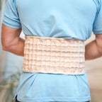 A person wearing the Therava™ Press Belt by Aurenza Shop, demonstrating its adjustable support around the waist.